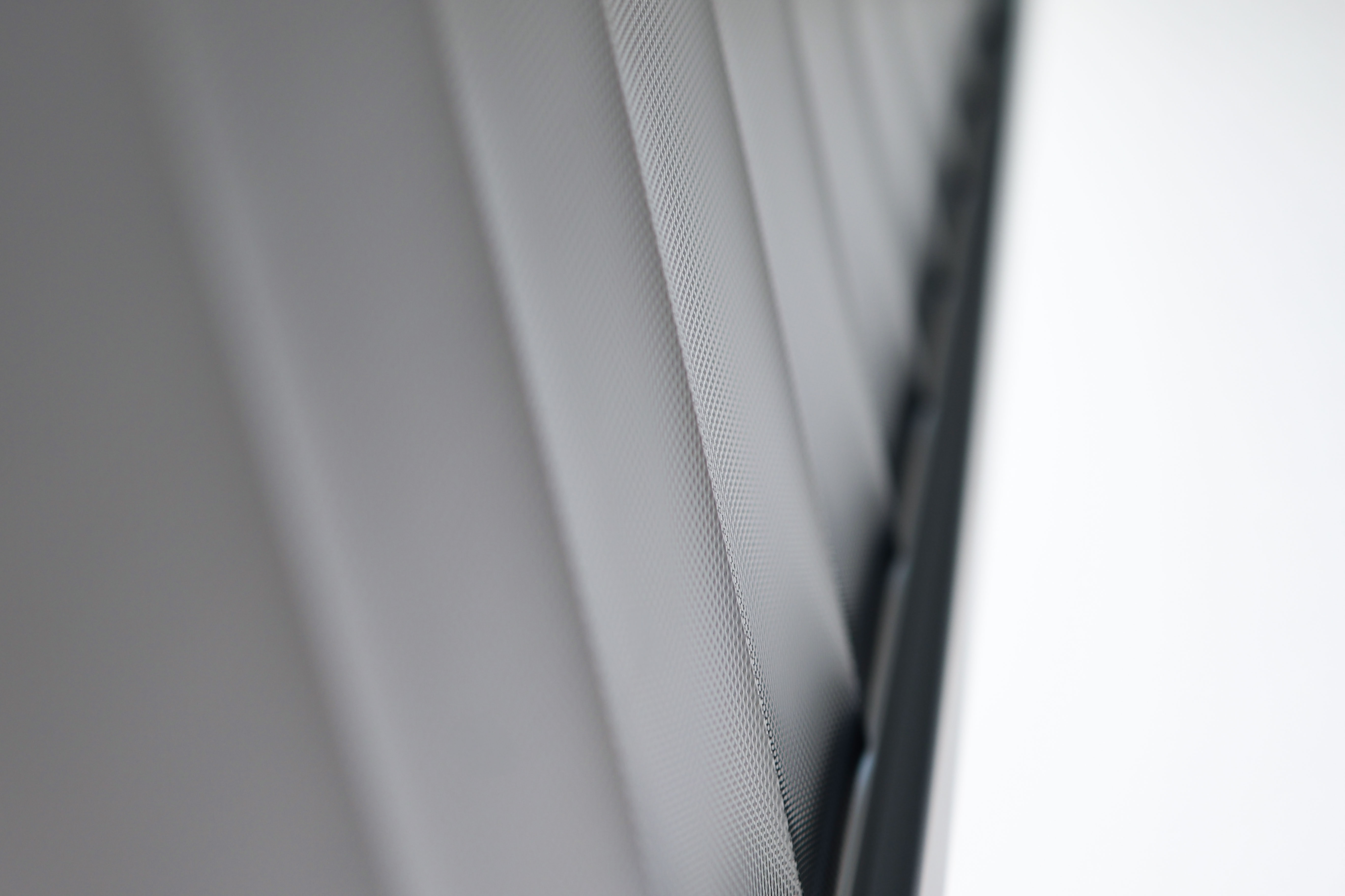 Close-up of a shielding roller shade at the window